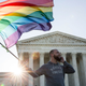 : Same-sex marriage supporter Vin Testa, of Washington, DC, waves a rainbow pride flag near the Supreme Court, April 28, 2015, in Washington, DC. On Tuesday, the Supreme Court will hear arguments concerning whether same-sex marriage is a constitutional right, with decisions expected in June.
